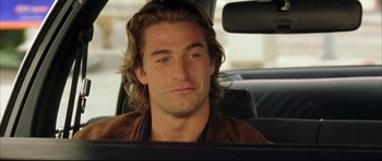 Movie still from “Dark Blue” (2002), directed by Ron Shelton – A person sitting in a car; Close Up shot, Over the shoulder angle