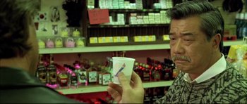 Movie still from “Dark Blue” (2002), directed by Ron Shelton – A man is holding a cup in his hand; Close Up shot, Low angle