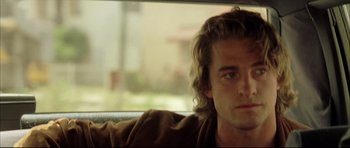 Movie still from “Dark Blue” (2002), directed by Ron Shelton – A person sitting in a car; Close Up shot, Low angle