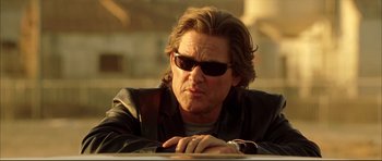 Movie still from “Dark Blue” (2002), directed by Ron Shelton – A person wearing a jacket and sunglasses; Close Up shot, Low angle