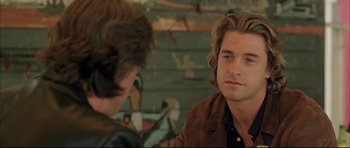 Movie still from “Dark Blue” (2002), directed by Ron Shelton – A man sitting in front of another man in front of a wall; Close Up shot, Over the shoulder angle