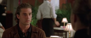 Movie still from “Dark Blue” (2002), directed by Ron Shelton – A man sitting at a table in front of a woman; Close Up shot, Over the shoulder angle