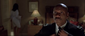 Movie still from “Dark Blue” (2002), directed by Ron Shelton – A person wearing a suit and tie; Close Up shot, Low angle