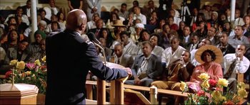 Movie still from “Dark Blue” (2002), directed by Ron Shelton – A man standing at a podium in front of a crowd; Medium shot, Low angle