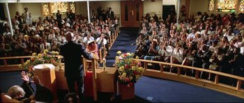Movie still from “Dark Blue” (2002), directed by Ron Shelton – A crowd of people sitting in front of a podium; Extreme Wide shot, High angle