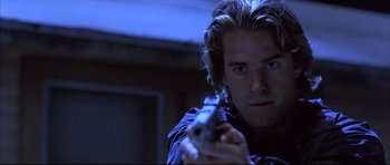 Movie still from “Dark Blue” (2002), directed by Ron Shelton – A person holding a gun; Close Up shot, Low angle