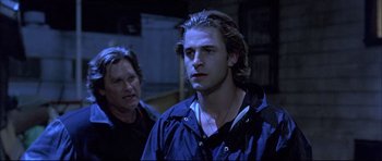 Movie still from “Dark Blue” (2002), directed by Ron Shelton – A young man and his mother in a dark room; Close Up shot, Over the shoulder angle