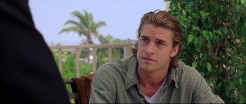 Movie still from “Dark Blue” (2002), directed by Ron Shelton – A man sitting on top of a wooden bench; Close Up shot, Over the shoulder angle