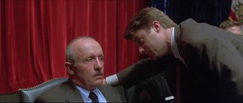 Movie still from “Dark Blue” (2002), directed by Ron Shelton – A man with his arm around another man's shoulder; Close Up shot, Low angle