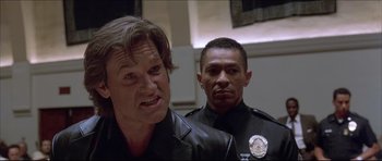 Movie still from “Dark Blue” (2002), directed by Ron Shelton – Two police officers standing next to each other in a room; Close Up shot, Low angle