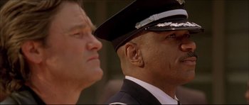 Movie still from “Dark Blue” (2002), directed by Ron Shelton – A man in a police uniform and another man in a uniform looking at something; Close Up shot, Low angle
