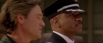 Movie still from “Dark Blue” (2002), directed by Ron Shelton – A man in a police uniform and a man in a suit; Close Up shot, Low angle