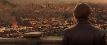 Movie still from “Dark Blue” (2002), directed by Ron Shelton – A man looking out over a city at sunset; Extreme Wide shot, Over the shoulder angle