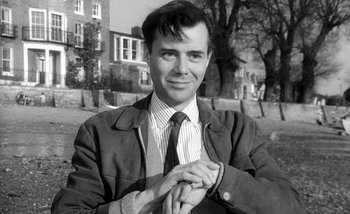 Movie still from “Darling” (1965), directed by John Schlesinger – Black and white photograph of a man wearing a suit and tie; Close Up shot, Low angle