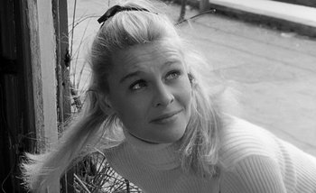 Movie still from “Darling” (1965), directed by John Schlesinger – A black and white photo of a woman with a bow in her hair; Close Up shot, Low angle