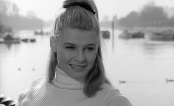 Movie still from “Darling” (1965), directed by John Schlesinger – A young woman with long blonde hair wearing a white sweater; Close Up shot, Low angle