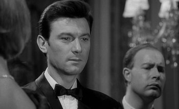 Movie still from “Darling” (1965), directed by John Schlesinger – Black and white photograph of a man in a tuxedo; Close Up shot, Over the shoulder angle
