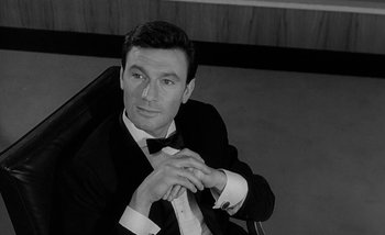 Movie still from “Darling” (1965), directed by John Schlesinger – Black and white photograph of a man wearing a tuxedo; Close Up shot, High angle