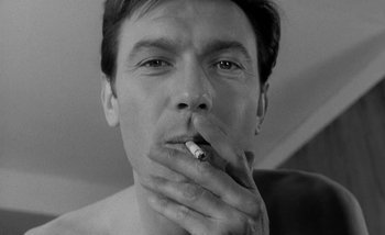 Movie still from “Darling” (1965), directed by John Schlesinger – A person smoking a cigarette; Close Up shot, Low angle