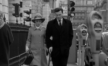 Movie still from “Darling” (1965), directed by John Schlesinger – A man and a woman walking down a street; Medium shot, Low angle