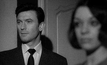 Movie still from “Darling” (1965), directed by John Schlesinger – A black and white photo of a man and a woman; Close Up shot, Over the shoulder angle