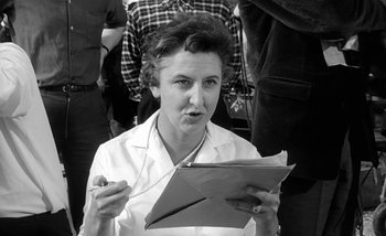 Movie still from “Darling” (1965), directed by John Schlesinger – An old photo of a woman holding an envelope; Close Up shot, Low angle