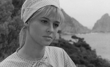 Movie still from “Darling” (1965), directed by John Schlesinger – Black and white photograph of a woman wearing a head scarf; Close Up shot, Low angle