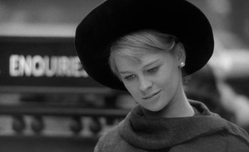 Movie still from “Darling” (1965), directed by John Schlesinger – A black and white photo of a woman wearing a hat; Close Up shot, Low angle