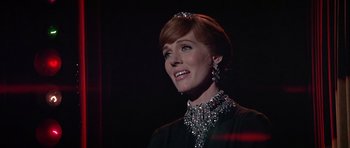 Movie still from “Darling Lili” (1970), directed by Blake Edwards – A woman with red hair wearing a black dress and a tiara; Close Up shot, Low angle