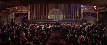 Movie still from “Darling Lili” (1970), directed by Blake Edwards – A large crowd of people are in a large auditorium; Extreme Wide shot, High angle