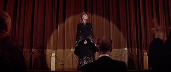 Movie still from “Darling Lili” (1970), directed by Blake Edwards – A woman standing on a stage in front of an audience; Wide shot, Low angle