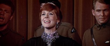 Movie still from “Darling Lili” (1970), directed by Blake Edwards – A person wearing a dress and a necklace; Close Up shot, Low angle