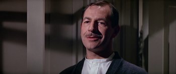 Movie still from “Darling Lili” (1970), directed by Blake Edwards – A person wearing a suit and tie; Close Up shot, Low angle