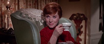 Movie still from “Darling Lili” (1970), directed by Blake Edwards – A woman sitting in a chair holding a tea cup; Close Up shot, High angle