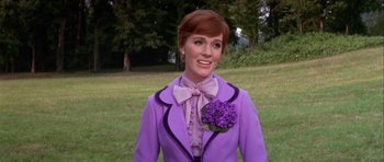 Movie still from “Darling Lili” (1970), directed by Blake Edwards – A woman in a purple outfit standing in a field; Medium shot, Low angle