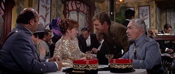 Movie still from “Darling Lili” (1970), directed by Blake Edwards – A man and a woman sitting at a dinner table; Medium shot, Over the shoulder angle