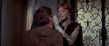 Movie still from “Darling Lili” (1970), directed by Blake Edwards – A woman putting lipstick on a man's face; Close Up shot, Over the shoulder angle