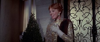 Movie still from “Darling Lili” (1970), directed by Blake Edwards – A woman in a sequined dress holding onto a glove; Medium shot, Low angle