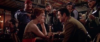 Movie still from “Darling Lili” (1970), directed by Blake Edwards – A man and a woman sitting at a table; Medium shot, High angle