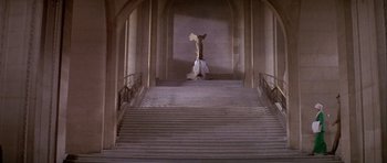 Movie still from “Darling Lili” (1970), directed by Blake Edwards – A statue of an angel on top of a staircase; Extreme Wide shot, High angle