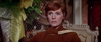 Movie still from “Darling Lili” (1970), directed by Blake Edwards – A person wearing a suit and tie; Close Up shot, Low angle