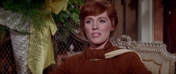 Movie still from “Darling Lili” (1970), directed by Blake Edwards – A person sitting on a chair; Close Up shot, Low angle
