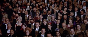 Movie still from “Darling Lili” (1970), directed by Blake Edwards – A large group of people sitting in a room; Wide shot, High angle