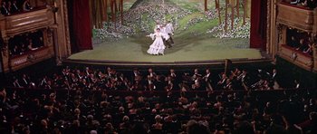 Movie still from “Darling Lili” (1970), directed by Blake Edwards – A scene of a stage with people in the background; Extreme Wide shot, High angle