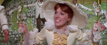 Movie still from “Darling Lili” (1970), directed by Blake Edwards – A person wearing a hat and a dress; Close Up shot, Low angle