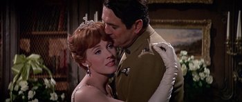 Movie still from “Darling Lili” (1970), directed by Blake Edwards – A man and a woman are hugging in a room; Close Up shot, Over the shoulder angle