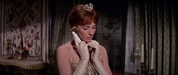 Movie still from “Darling Lili” (1970), directed by Blake Edwards – A woman holding a phone up to her ear; Close Up shot, Low angle
