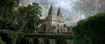 Movie still from “Darling Lili” (1970), directed by Blake Edwards – A group of people standing in front of an old church; Extreme Wide shot, High angle