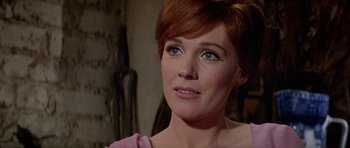 Movie still from “Darling Lili” (1970), directed by Blake Edwards – A person wearing a pink shirt; Close Up shot, Over the shoulder angle