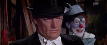 Movie still from “Darling Lili” (1970), directed by Blake Edwards – A person wearing a suit and a top hat; Close Up shot, Over the shoulder angle